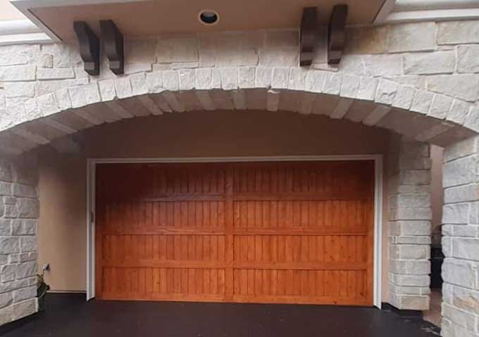Custom wood-look garage door with replacement panels