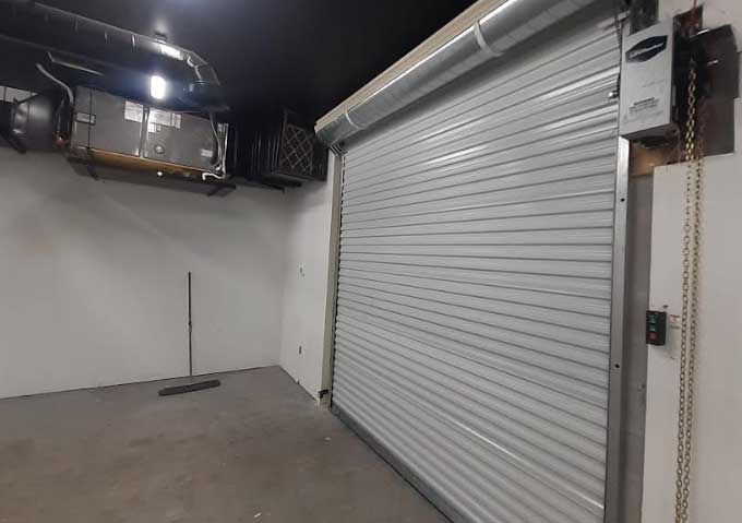 Commercial roll-up door with wall-mounted opener