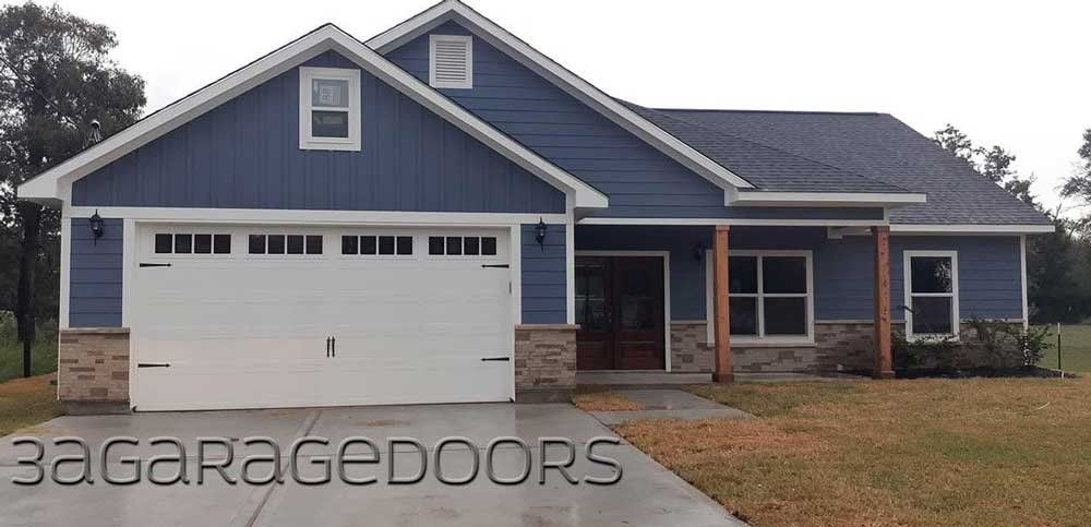 Blue home with white carriage-style garage door