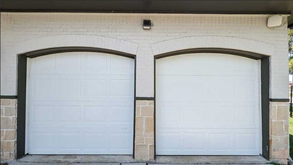 Pair of white arched garage doors