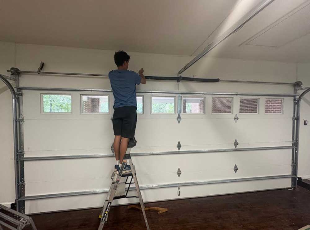 3A technician servicing a garage door